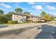 Apartment building with covered parking, lush lawns, and mature landscaping at 5265 E Bay Dr # 424, Clearwater, FL 33764