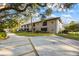 Apartment building with patios, mature trees, well-manicured lawns, and parking at 5265 E Bay Dr # 424, Clearwater, FL 33764