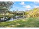 Community pond with a fountain, mature trees, and lush green landscaping at 5265 E Bay Dr # 424, Clearwater, FL 33764