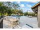 Relaxing poolside area with lounge chairs and shaded seating under mature trees at 5265 E Bay Dr # 424, Clearwater, FL 33764