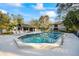 Outdoor swimming pool with a clubhouse and lounge chairs for community residents at 5265 E Bay Dr # 424, Clearwater, FL 33764