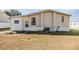 Exterior view of the mobile home with light beige siding at 5330 Dean Dairy Rd, Zephyrhills, FL 33541