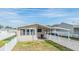 Front view of manufactured home with white picket fence at 5330 Dean Dairy Rd, Zephyrhills, FL 33541