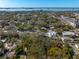 Aerial view of property with trees in residential neighborhood near the water at 620 Scotland St, Dunedin, FL 34698