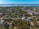 Aerial view of property with trees in residential neighborhood near the water at 620 Scotland St, Dunedin, FL 34698