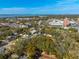 Aerial view of property with trees in residential neighborhood near the water at 620 Scotland St, Dunedin, FL 34698