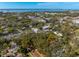 Aerial view of property with trees in residential neighborhood near the water at 620 Scotland St, Dunedin, FL 34698