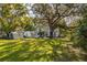 Large backyard with mature trees offers ample space for outdoor activities and relaxation at 620 Scotland St, Dunedin, FL 34698