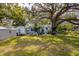 Expansive backyard with mature trees and a shed provides plenty of space for outdoor enjoyment at 620 Scotland St, Dunedin, FL 34698