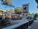 Outdoor seating area at Dunedin Brewery, featuring picnic tables, umbrellas, and a brewery sign at 620 Scotland St, Dunedin, FL 34698