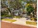 Charming single-story home with a well-manicured lawn and mature trees providing shade at 620 Scotland St, Dunedin, FL 34698