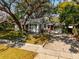 Charming single-story home with a well-manicured lawn and mature trees providing shade at 620 Scotland St, Dunedin, FL 34698