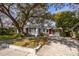 Charming single-story home with a well-manicured lawn and mature trees providing shade at 620 Scotland St, Dunedin, FL 34698