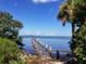 Picturesque view of a dilapidated pier extending into the bay on a clear sunny day at 620 Scotland St, Dunedin, FL 34698