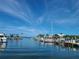 Beautiful view of boats docked at a marina with palm trees and waterfront property on a sunny day at 620 Scotland St, Dunedin, FL 34698