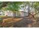 Large backyard with view of the home and lots of trees at 6905 122Nd Dr, Largo, FL 33773