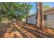 Backyard of the home showing the exterior of the house and some trees at 6905 122Nd Dr, Largo, FL 33773