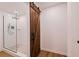 Luxurious bathroom features stone shower, and a rustic barn door at 6905 122Nd Dr, Largo, FL 33773