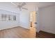 Well-lit bedroom features white walls, wood-look flooring, and an open doorway to a bathroom at 6905 122Nd Dr, Largo, FL 33773