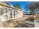 Exterior showing the home's patio area with glass paneled doors and concrete surface at 6905 122Nd Dr, Largo, FL 33773