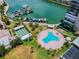 Aerial view showing resort-style pool, marina, and building at 7400 Sun Island S Dr # 207, South Pasadena, FL 33707