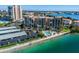 Aerial view of waterfront condo building and pool area at 7400 Sun Island S Dr # 207, South Pasadena, FL 33707