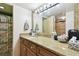 Bathroom with granite countertop, large mirror, and shower at 7400 Sun Island S Dr # 207, South Pasadena, FL 33707