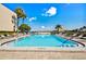 Inviting heated pool with plenty of lounge chairs at 7400 Sun Island S Dr # 207, South Pasadena, FL 33707