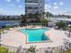 Community pool with spa and surrounding lounge chairs at 7400 Sun Island S Dr # 207, South Pasadena, FL 33707