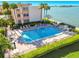 Community pool with plenty of lounge chairs at 7400 Sun Island S Dr # 207, South Pasadena, FL 33707