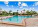 Community pool with patio furniture and lush landscaping at 7400 Sun Island S Dr # 207, South Pasadena, FL 33707