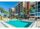 Resort-style pool and spa with surrounding lounge chairs at 7400 Sun Island S Dr # 207, South Pasadena, FL 33707