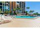 Relaxing community pool with plenty of lounge chairs for sunbathing at 7400 Sun Island S Dr # 207, South Pasadena, FL 33707