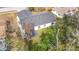 Aerial view of the house featuring a well-maintained roof, spacious yard, and mature trees at 7800 Willow Brook Ct, Hudson, FL 34667