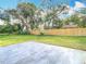 Large, grassy backyard enclosed by a new wood fence; perfect for outdoor enjoyment and privacy at 7800 Willow Brook Ct, Hudson, FL 34667