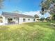 Home exterior with covered patio and lush backyard, blending indoor and outdoor living spaces at 7800 Willow Brook Ct, Hudson, FL 34667