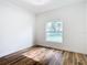 Well-lit bedroom featuring wood-look floors and a large window at 7800 Willow Brook Ct, Hudson, FL 34667