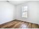 Bright bedroom featuring wood-look floors and a window at 7800 Willow Brook Ct, Hudson, FL 34667