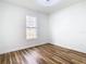 Empty bedroom with hardwood floors and ample natural light through the window at 7800 Willow Brook Ct, Hudson, FL 34667