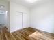 Bright bedroom with wood-look flooring and white sliding closet doors at 7800 Willow Brook Ct, Hudson, FL 34667