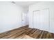 Light-filled bedroom with wood-look floors and a closet with white doors at 7800 Willow Brook Ct, Hudson, FL 34667