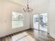 Bright dining room with sliding glass doors to the back patio and a modern chandelier at 7800 Willow Brook Ct, Hudson, FL 34667