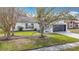 Charming home with a two-car garage, mature trees and a well-manicured lawn at 7800 Willow Brook Ct, Hudson, FL 34667