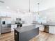 Modern kitchen featuring stainless steel appliances, a center island, and white cabinets at 7800 Willow Brook Ct, Hudson, FL 34667