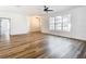 Well-lit living room showing hardwood flooring and bright white walls at 7800 Willow Brook Ct, Hudson, FL 34667