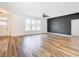 Large living room featuring hardwood floors, a modern accent wall and natural lighting at 7800 Willow Brook Ct, Hudson, FL 34667