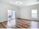 Bright living room with sliding glass doors to the back patio and a modern ceiling fan at 7800 Willow Brook Ct, Hudson, FL 34667