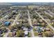 This aerial view shows houses on tree-lined streets in a quiet neighborhood at 8303 Croton Ave, Tampa, FL 33619