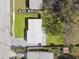 This aerial view displays the house, yard, roof, driveway and neighborhood at 8303 Croton Ave, Tampa, FL 33619