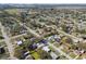 This aerial view shows the houses and tree-lined streets in a well-established neighborhood at 8303 Croton Ave, Tampa, FL 33619